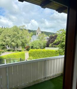 a balcony with a view of a church at FeWo Linneweber in Willingen