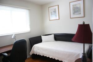 a bedroom with a bed and a desk and a window at Bungalow in Green Area in Ottawa