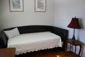 a bed in a room with a lamp on a table at Bungalow in Green Area in Ottawa
