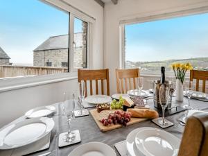 a dining room table with a plate of food on it at Stable Cottage - Uk10694 in Amroth