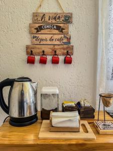 eine Küchentheke mit einer Kaffeekanne auf dem Tisch in der Unterkunft Chalé Quinta São Miguel 01 - Econômico in Santo Antônio do Pinhal