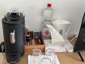 a counter with a coffee maker and a blender at BasilStay Studiowohnung in Basel