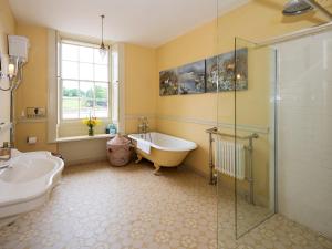 a bathroom with a tub and a shower and a sink at Bell Flat - Uk42250 in Broughton