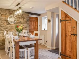 a dining room with a wooden table and chairs at Uk45895 - Cross House Cottage in Kirkby Lonsdale