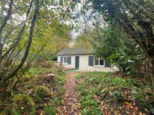 a small white house in the middle of a forest at House in forest proche GR and circuit in Saint-Mars-la-Brière
