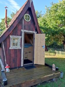 a dog house with a door open on a deck at cabane féérique in Pléneuf-Val-André