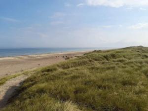a view of the beach from the top of a hill at 6 person holiday home in Fjerritslev in Fjerritslev +25 photos