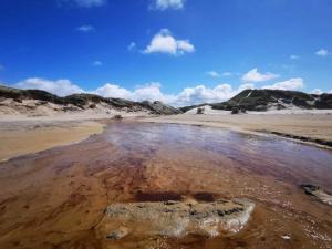 a pool of water in the sand on a beach at 6 person holiday home in Fjerritslev in Fjerritslev