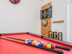a red pool table with billiard balls on it at 14 person holiday home in Glesborg in Glesborg
