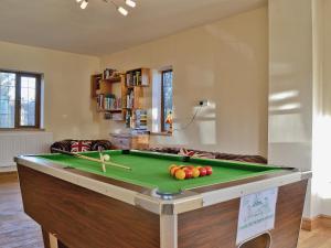 a room with a pool table with paddles on it at Celyn in Montgomery