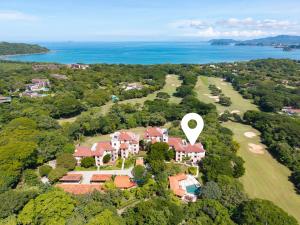 an aerial view of a mansion with a large house at Treetop Ocean View Penthouse - Jobo 15 in Playa Conchal