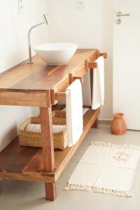 a bathroom with a wooden counter with a sink at Casa Aia in Aracaju