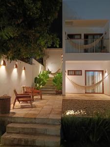 a house with a bench and stairs at night at Casa Aia in Aracaju