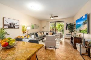 a living room with a couch and a table at Wailea Luxury Retreat Walk to Beach & Shops in Wailea