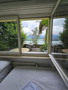 a bedroom with a window and a view of the water at Queen Home1 in Lucerne