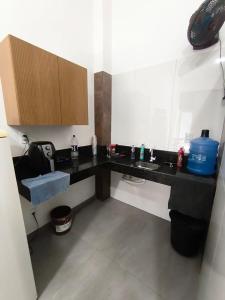 a bathroom with a black counter and a sink at Lar Doce Lar Realizando Sono!!! in Arcos