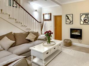 a living room with a couch and a table at The Court House - Uk43908 in Silloth