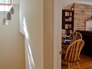 a dining room with a table and two chairs at The Old Vicarage in Curbar
