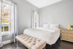 a white bedroom with a bed and a window at Modern 5BR Home Perfect for Families in Niagara Falls