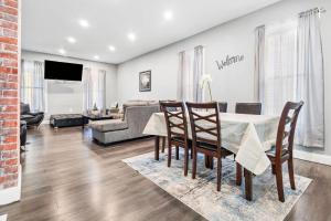 a living room with a table and chairs and a couch at Modern 5BR Home Perfect for Families in Niagara Falls
