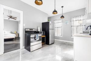 a kitchen with a refrigerator and a stove top oven at Modern 5BR Home Perfect for Families in Niagara Falls +27 photos