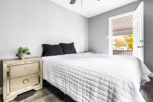 a bedroom with a bed and a window at Modern 5BR Home Perfect for Families in Niagara Falls