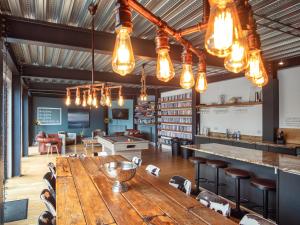 a large wooden table in a room with a library at Chapelburn in Lawers