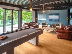 a living room with a pool table in it at Chapelburn in Lawers