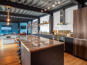 an industrial kitchen with a large island in the middle at Chapelburn in Lawers +18 photos