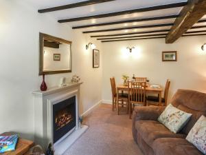 a living room with a couch and a fireplace at Lavender Cottage in Shrewsbury
