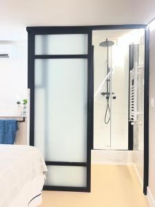 a glass door in a bedroom with a shower at Castillo 22 in Oropesa +10 photos
