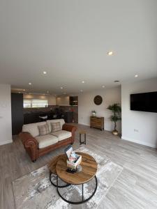 a living room with a couch and a table at Stylish Cosy Stunning View Villa in Kirkwall, Free Parking and WiFi in Orkney