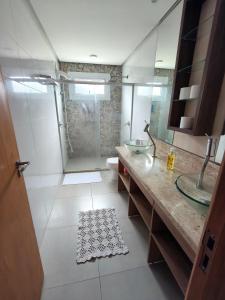 a bathroom with a shower and a sink and a toilet at Casa em Dois Irmãos in Dois Irmãos