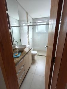 a bathroom with a sink and a toilet at Casa em Dois Irmãos in Dois Irmãos +23 photos