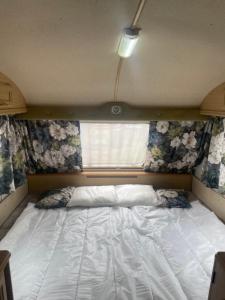 a bed in a small room with a window at Second&Home in Przeźmierowo