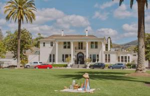 a woman sitting on a blanket in front of a house at Romantic Napa Escape Prime Location in Vichy Springs