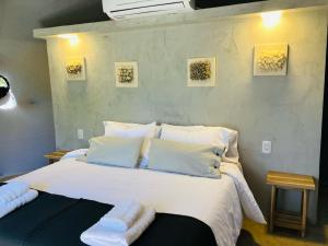 ein Schlafzimmer mit einem großen Bett mit weißen Laken und Kissen in der Unterkunft Glamping en zona de Bodegas Luján de Cuyo Mendoza in La Porteña + 21 Fotos