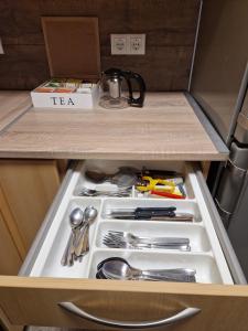 a drawer filled with utensils in a kitchen at quiet apartment 2 in Rüsselsheim +13 photos