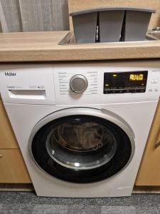 a white washing machine sitting in a kitchen at quiet apartment 2 in Rüsselsheim