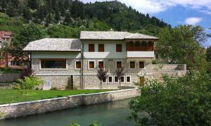 a house on the side of a river at Holiday Home Sarin Most in Stolac