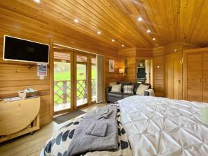 een slaapkamer met een groot bed en een flatscreen-tv bij Maple - Uk46284 in Camerton