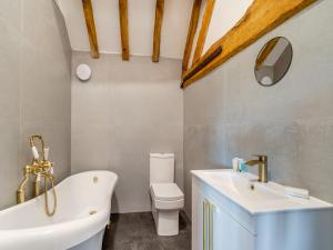 a bathroom with a sink and a tub and a toilet at Stable View Barn - Uk45938 in Corley +9 photos