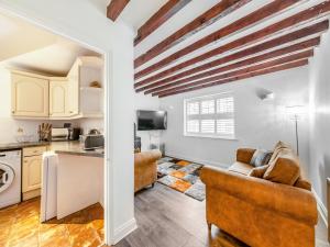 a kitchen and living room with a couch and a table at Rose Cottage - Uk45971 in Yarm