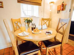 a wooden table with food and drinks on it at The Bakery - Uk6727 in Lydstep +9 photos