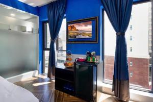 a bedroom with blue walls and blue drapes at Heritage hotel in Nha Trang