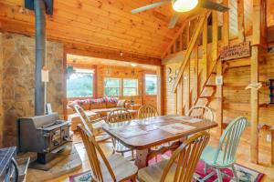 a dining room with a table and chairs and a stove at Secluded Mountain Cabin with Decks and Gazebo! in Brasstown