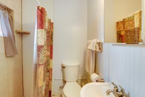 a white bathroom with a toilet and a sink at Secluded Mountain Cabin with Decks and Gazebo! in Brasstown +22 photos