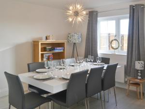 a dining room with a white table and chairs at Ad Gefrin in Acklington