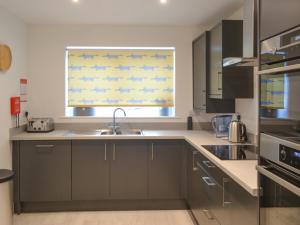 a kitchen with a sink and a window at Ad Gefrin in Acklington