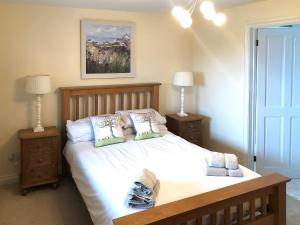 a bedroom with a large bed with two night stands at Chapman House in Parkham